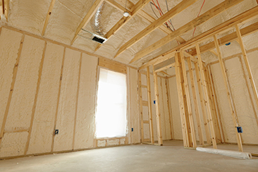 An iFOAM insulation contractor applying spray foam in an attic