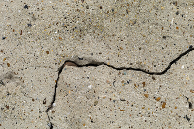 A crack in basement concrete slab that can be filled with canned expanding foam